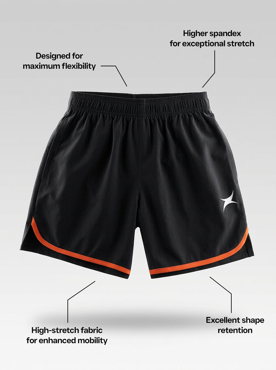 Black sports shorts with orange trims on a gray background, featuring text on the fabric properties.