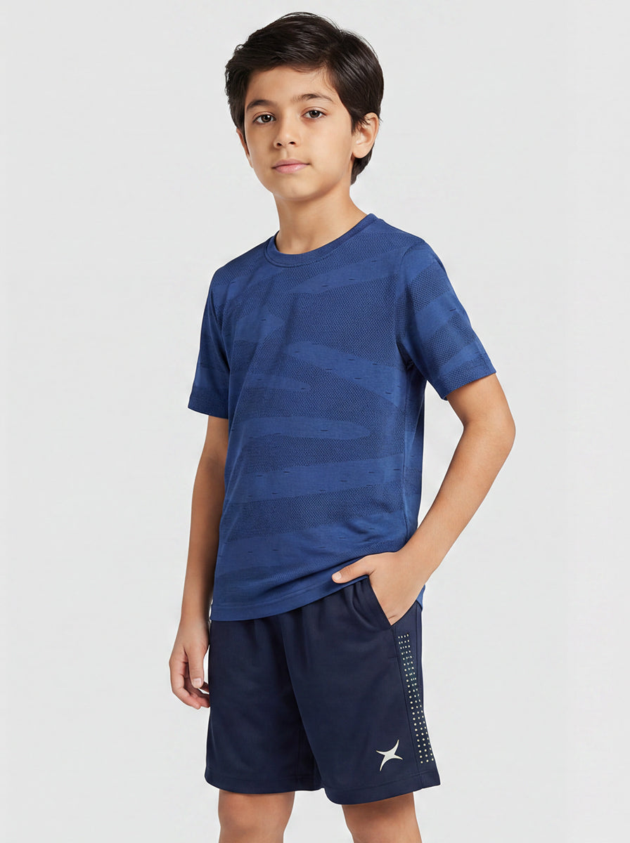Child wearing a blue sports outfit on a white background