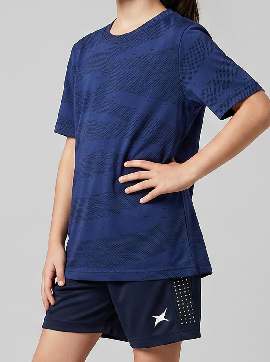A girl wearing a blue sports outfit with a gray background