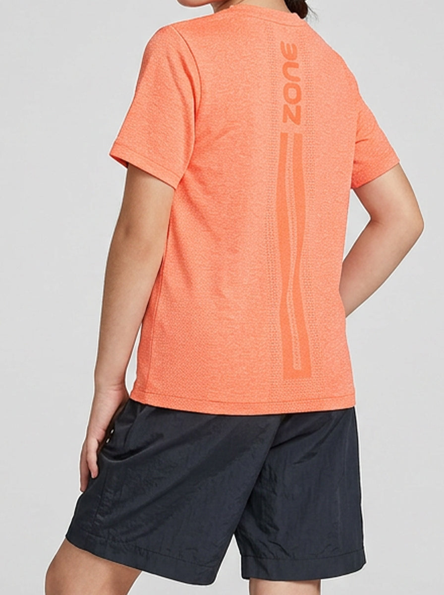 A girl wearing an orange sports shirt with 'Zone' branding on a gray background