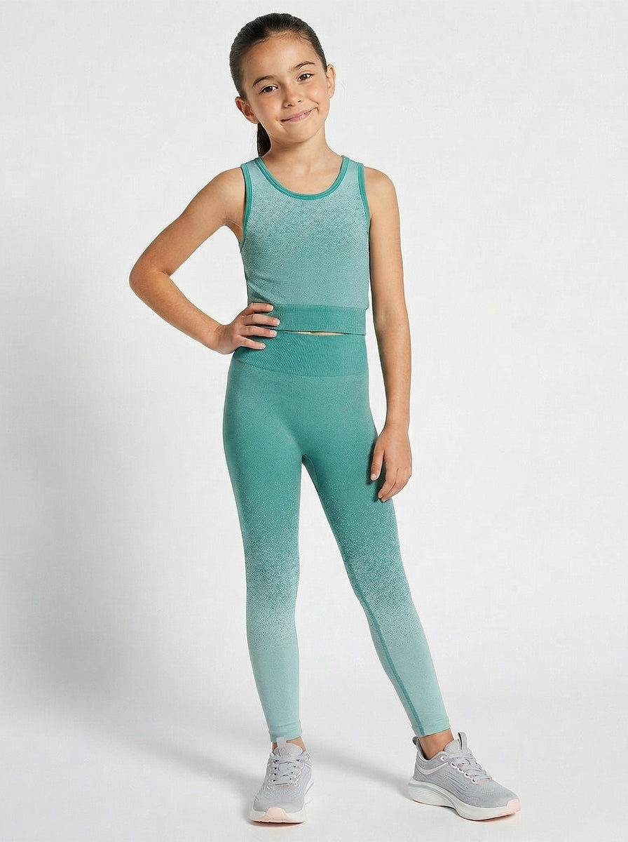 A girl wearing a green sports outfit on a white background