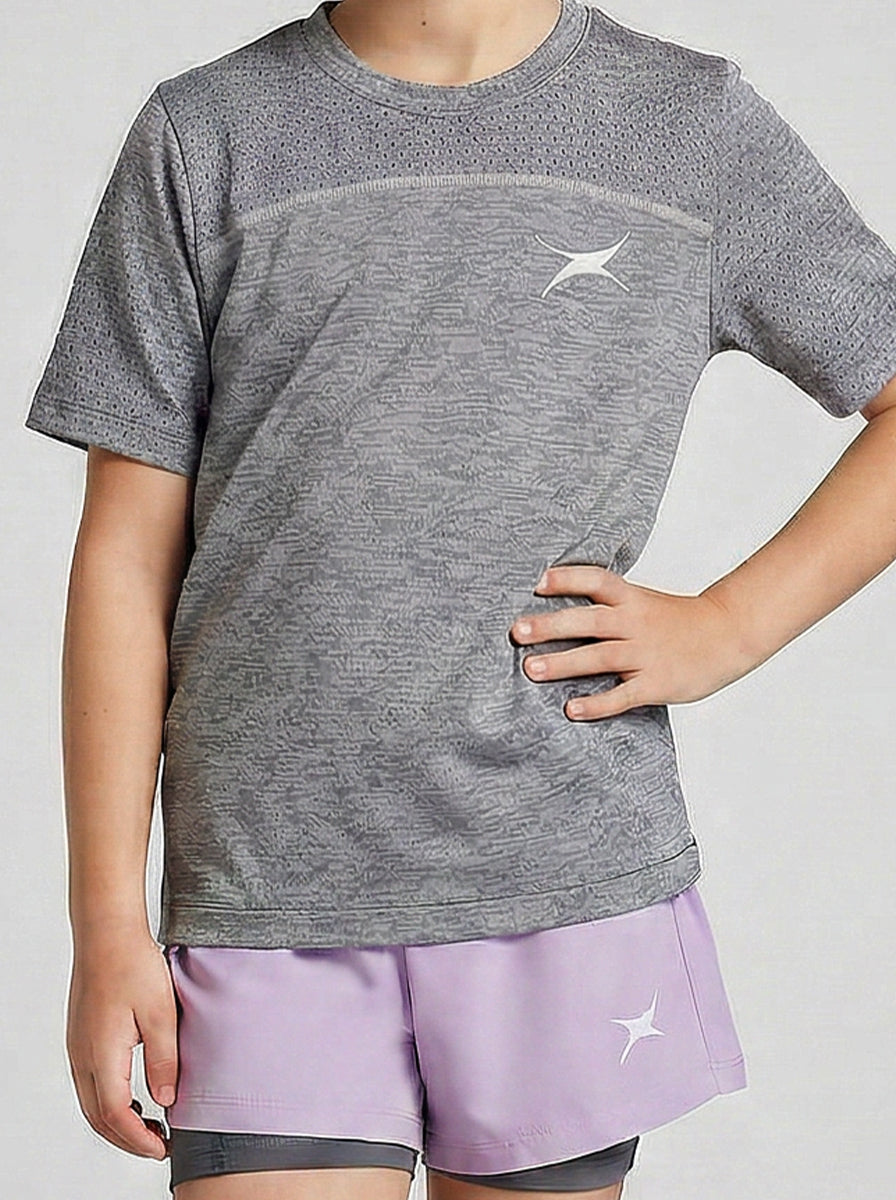Child wearing a gray t-shirt and purple shorts with a logo on a white background