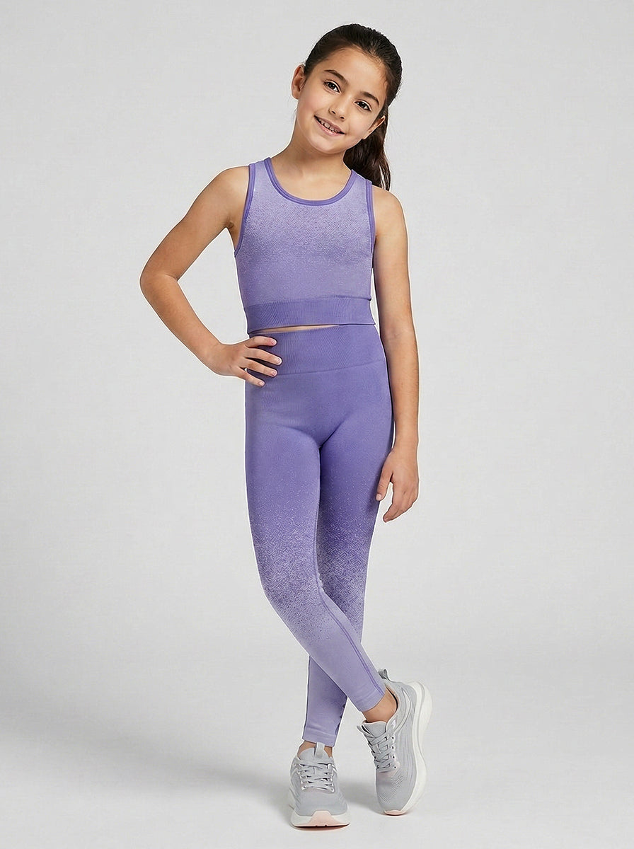 Girl wearing a purple sports outfit on a white background