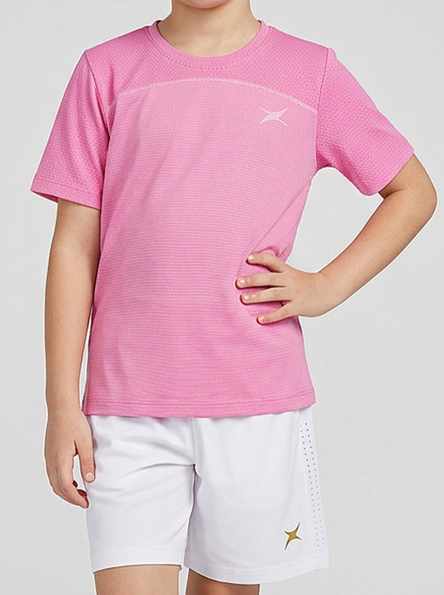 Child wearing a pink shirt and white shorts on a light gray background