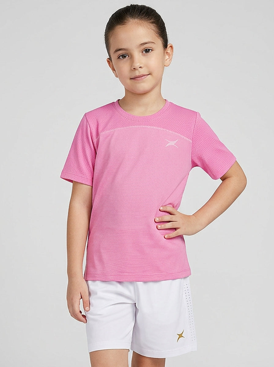 Child wearing a pink shirt and white shorts on a light gray background