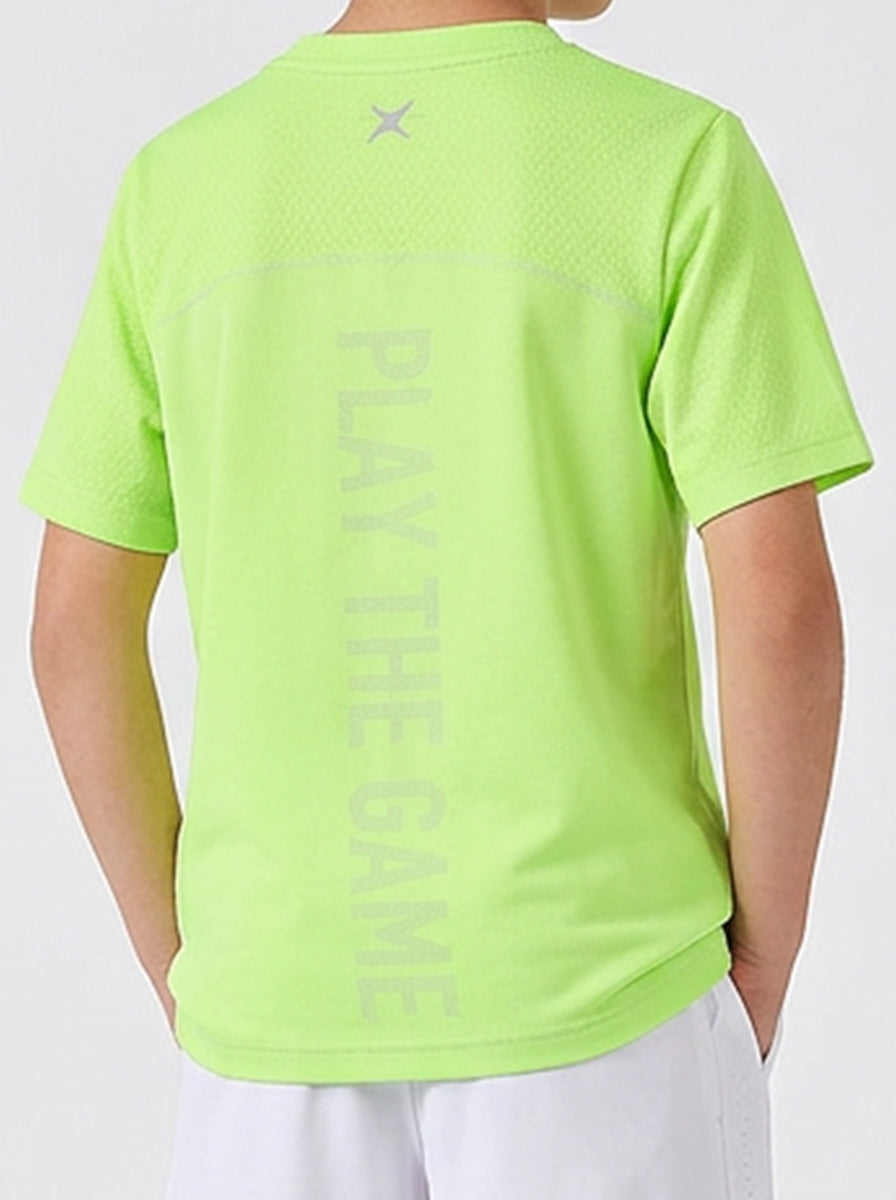 A boy wearing a bright green t-shirt with 'Play The Game' text on the back, on a white background