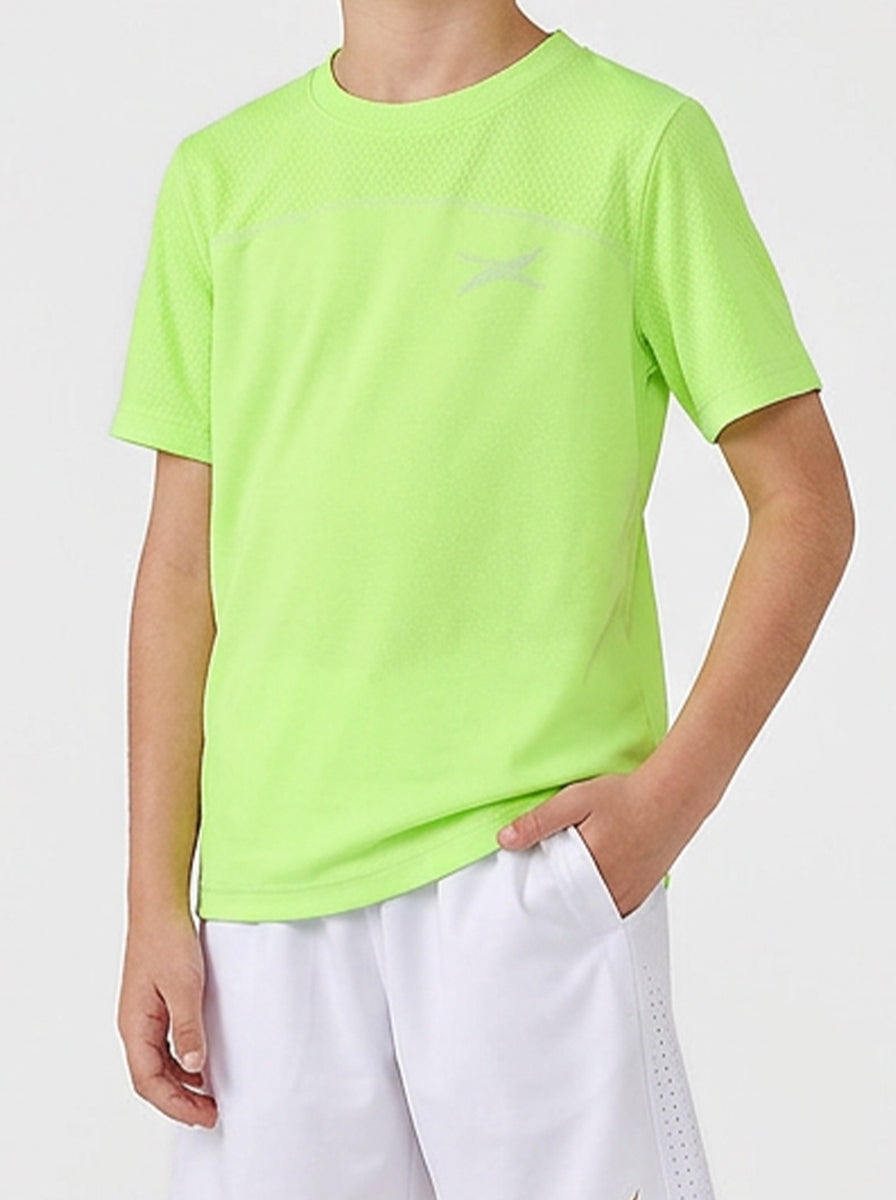 Child wearing a bright green sports t-shirt and white shorts on a light gray background