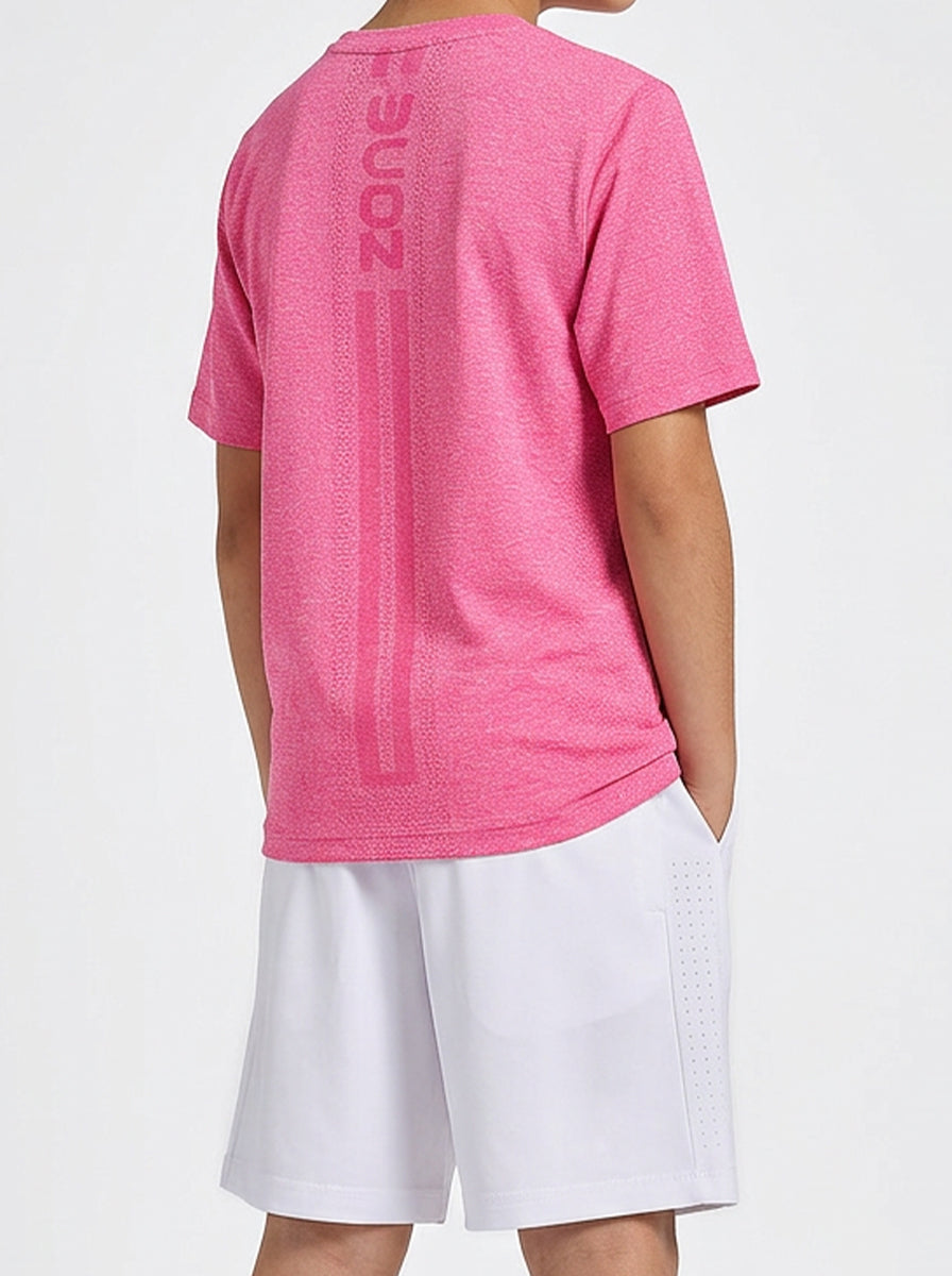 A boy wearing a pink sports t-shirt with 'Zone' branding on the back, paired with white shorts.