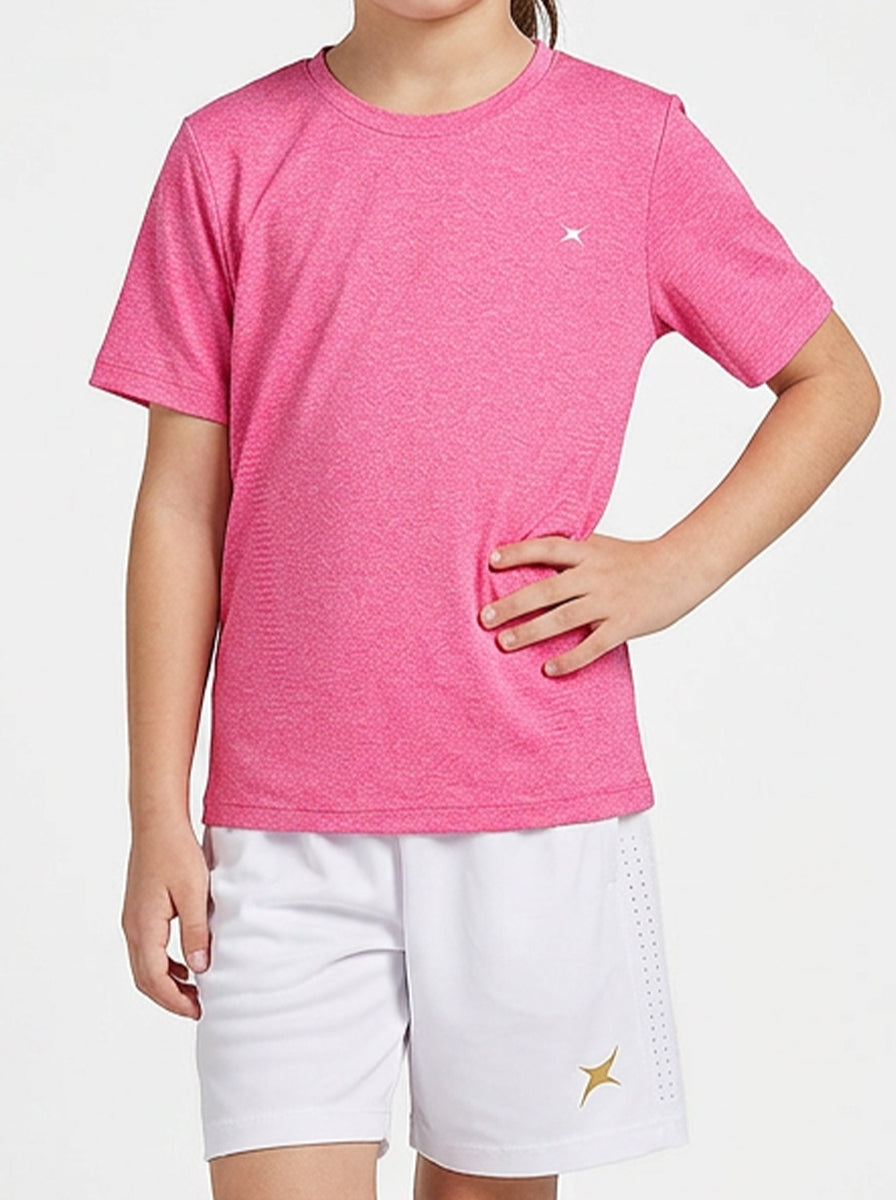 Child wearing a pink t-shirt and white shorts with a brand logo on a light gray background
