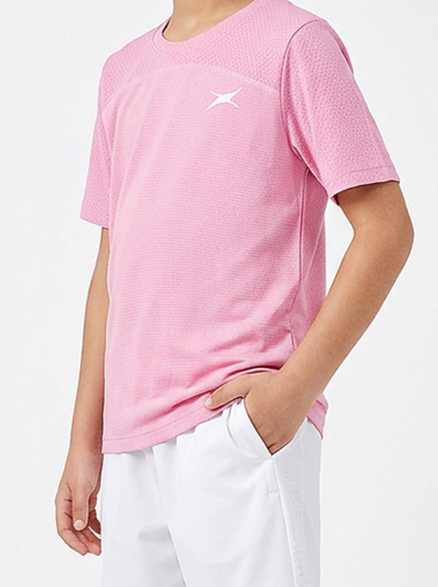 A boy wearing a pink t-shirt with a logo on a white background