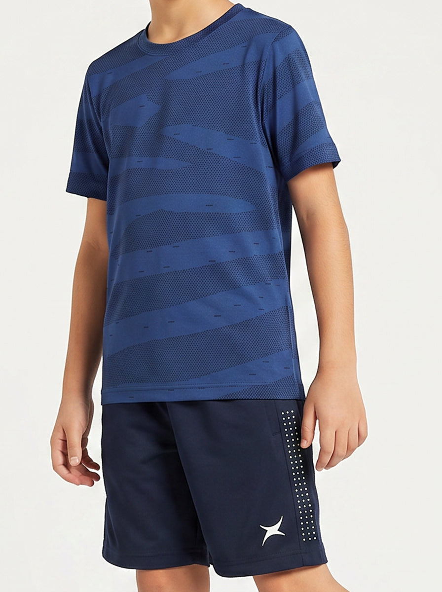 A boy wearing a blue sports outfit with a white logo on a white background