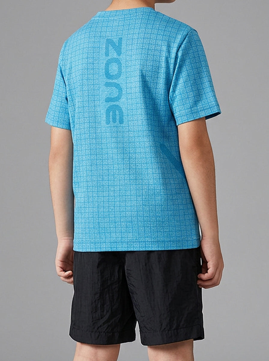 Child wearing a blue checkered sports t-shirt and black shorts on a white background