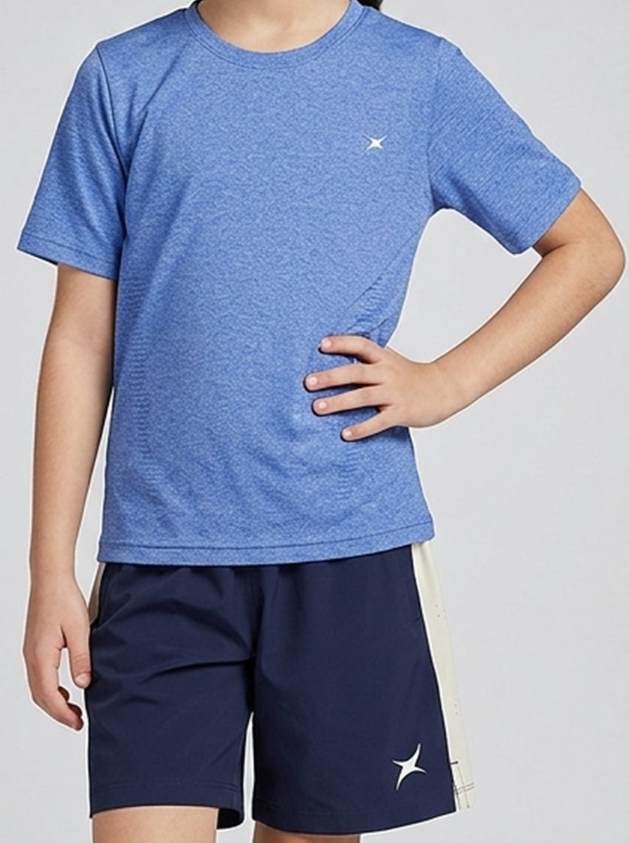 Child wearing a blue sports T-shirt and navy shorts with a logo on a light gray background