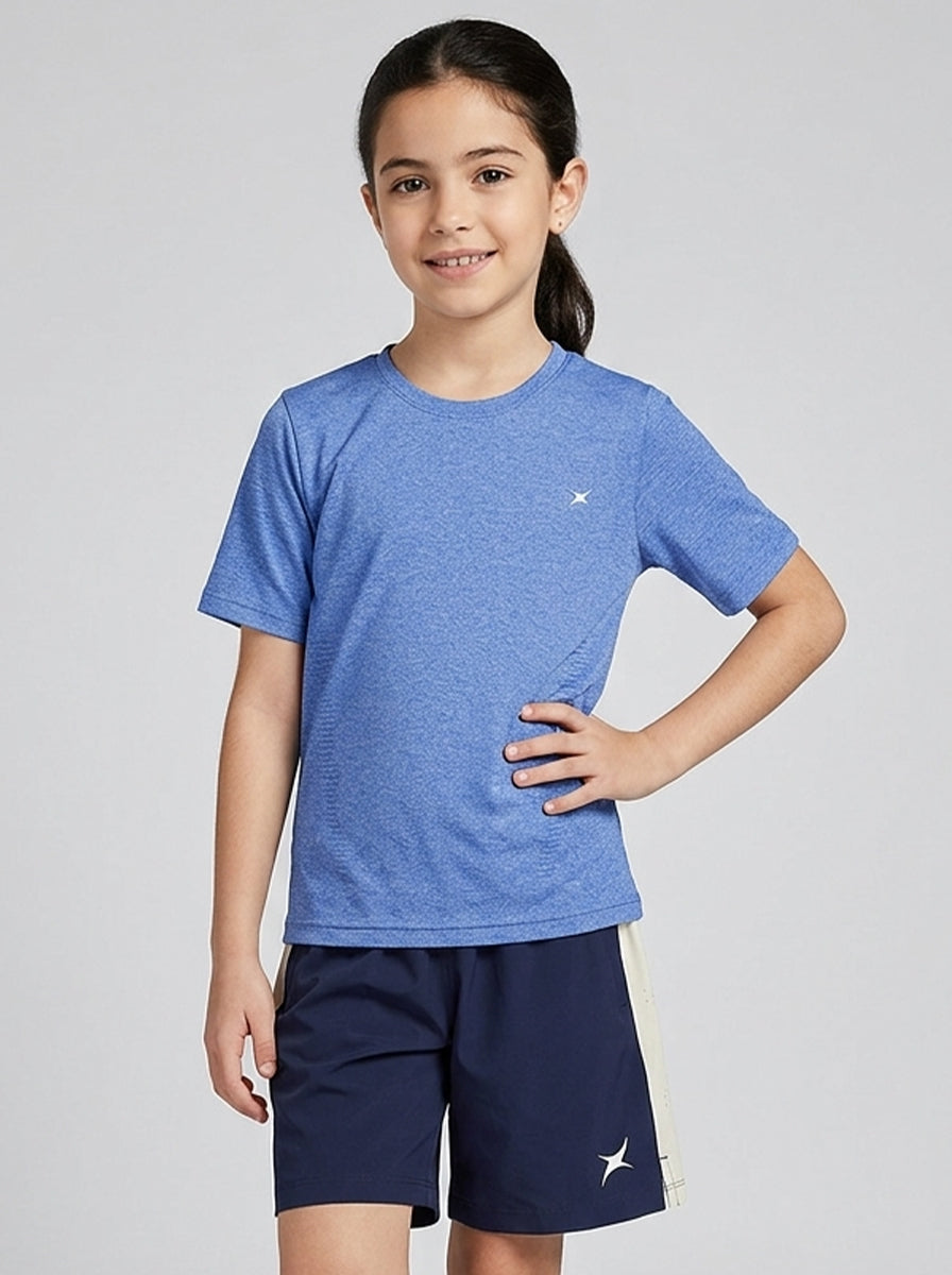 Child wearing a blue sports T-shirt and navy shorts on a light gray background